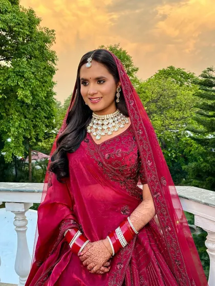 A full-length shot of this bride in her deep red lehenga. The entire look is a perfect blend of tradition and modern elegance.