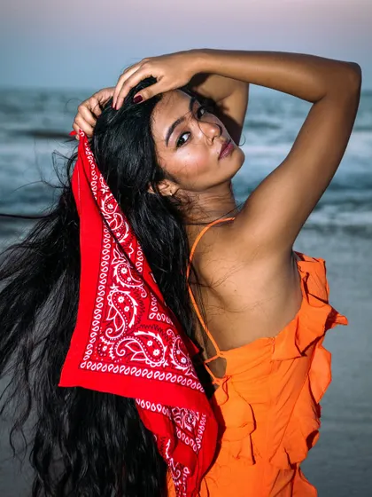 A dynamic shot using the bandana as a prop to create movement. The model's pose is strong and full of energy.