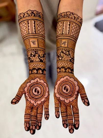 A beautiful design for a mom-to-be, with tiny baby feet inside a central mandala and "Pa" and "Ma" written in Hindi, celebrating the parents.