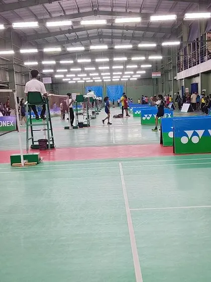A young player gets ready to return a serve, demonstrating the focus and readiness we instill in our athletes.