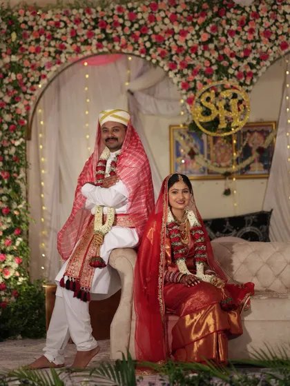 A traditional portrait of the Coorgi bride and groom. Her makeup is flawless, and she looks radiant in her red bridal attire.
