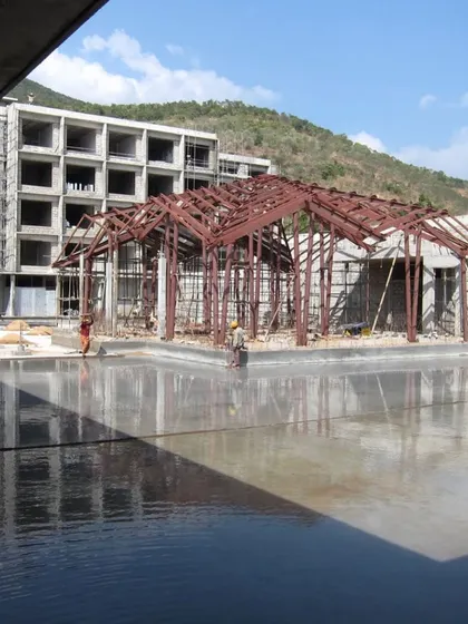 The steel skeleton of the Lotus Cafe during construction, revealing the complex engineering required to achieve its light, floating form.