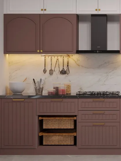 A view of the cooking area in the mauve kitchen, with a marble backsplash and practical storage.