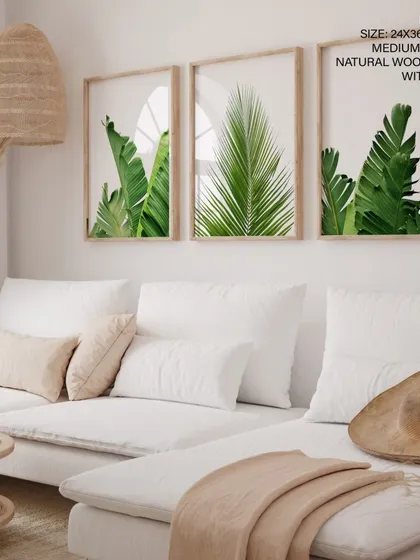 Bring the outdoors in with our set of three botanical leaf prints. This gallery wall, featuring lush banana and palm leaves in natural wood frames with glass, creates a fresh, calming atmosphere in any living room or bright space. Each piece is printed on high-quality canvas to ensure the greens stay vibrant for years.