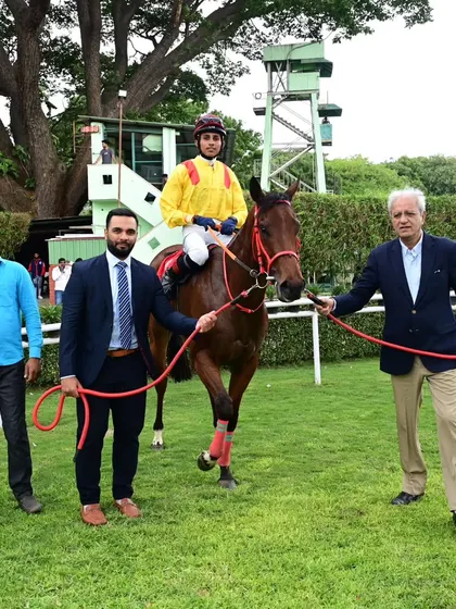 Credence, with jockey Ramswarup, poses with the winning connections.