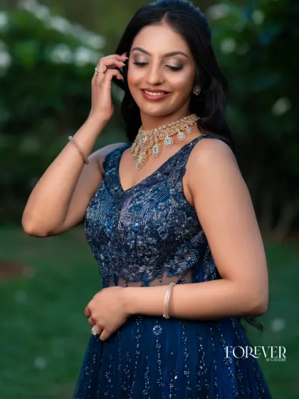 A close-up of the blue katdana corset gown. You can see the sheer paneling and the intricate beadwork on the bodice, which is designed to flatter and define the waist.