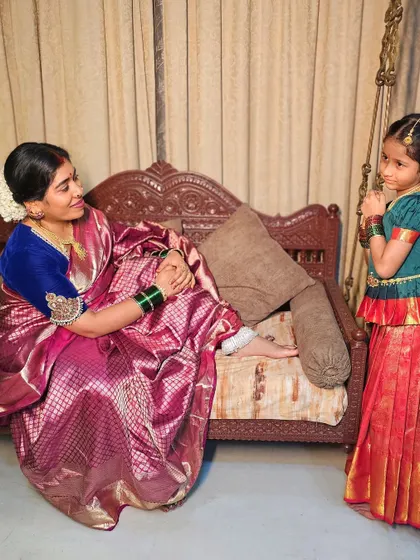 A sweet interaction between a mother and daughter, both ready for a celebration. I provide styling for all ages, ensuring everyone in the family looks their festive best.