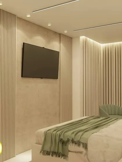 The TV wall in the sage green bedroom, featuring a minimalist design with fluted paneling.