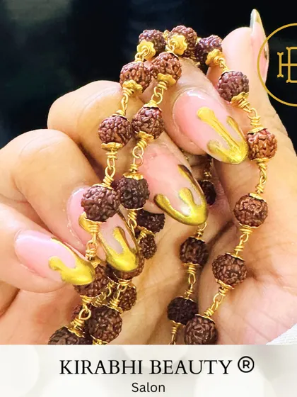 Another creative shot of the gold drip nails, showing how they can accessorize and complement your jewelry.