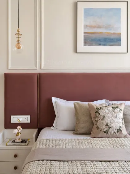The standout feature of this bedroom is the pink headboard, elegantly detailed with a golden patti inlay. This beautiful pop of color adds personality and a touch of luxury to the serene space.