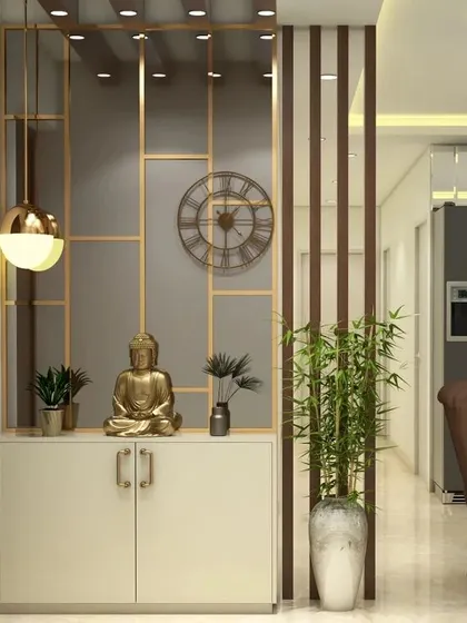 A sophisticated foyer design featuring a partition with gold metal accents. The console provides a serene display area for a Buddha statue and plants, creating a calm and elegant entrance.