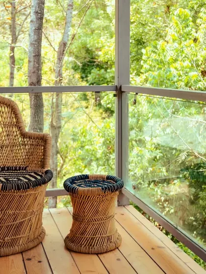 The balcony of our wooden cabin, a private space to sit and immerse yourself in the sights and sounds of the forest.
