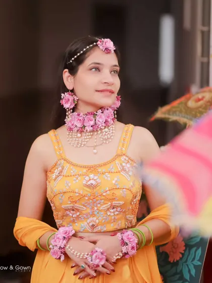 A beautiful portrait of the bride on her Haldi day. She looks radiant in her yellow outfit and floral jewellery, ready for the celebrations to begin.