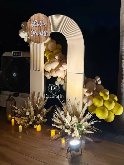 Another view of the modern "Let's Party" arch, showing how uplighting can transform the mood and highlight the textures of the decor.