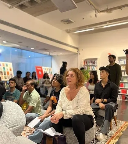 The audience listens intently during a multilingual performance. At our open mics, you will hear stories and poems in Hindi, Urdu, French, and English, celebrating the rich linguistic tapestry of our community.