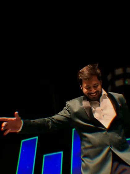Pointing to the crowd, engaging with guests during a dance sequence on stage. It's all about making a personal connection.