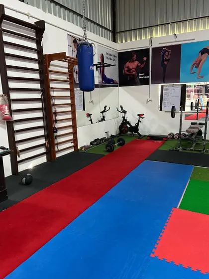 A look at our strength and conditioning area, complete with a Swedish ladder, punching bag, and weights. A complete fitness regimen is part of our gymnastics training.
