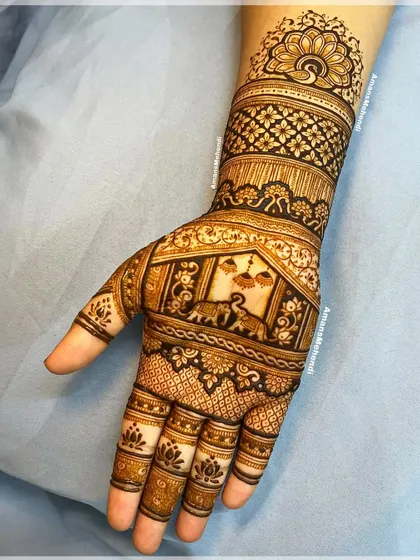 A full hand design featuring a procession of elephants and a central peacock motif. The intricate details and dense patterns make this a stunning bridal choice.