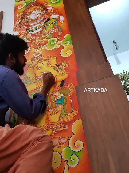 Here I am, working on a pooja room wall, painting a mural of Unnikannan and Ganesha. Painting directly on the wall integrates the art into the architecture of the home itself.