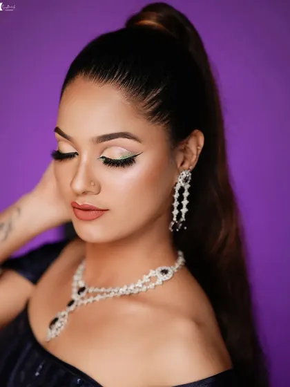 A close-up of the eye makeup, featuring a pop of green liner for a creative touch.
