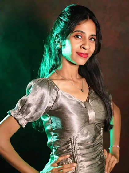A confident pose in the silver metallic dress, perfect for capturing a bold and stylish look in a studio setting.