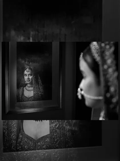 An artistic shot of the bride looking at her own framed portrait, a creative and meta-commentary on capturing memories.