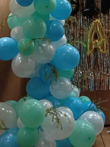 Detail of the balloon garland, showing the addition of faux greenery for a unique touch.