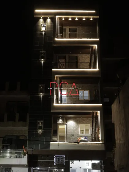 A duplicate of image 63, providing another look at the beautifully lit facade of The Cursive Abode at night.