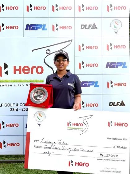 A solo shot of Lavanya Jadon celebrating her first professional win at the Hero WPGT, holding her prize check and trophy. A milestone moment in her journey from a junior to a professional golfer.