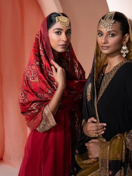 Two coordinated festive looks in red and black. This shows how I can style sisters or friends in complementary outfits for a family function.