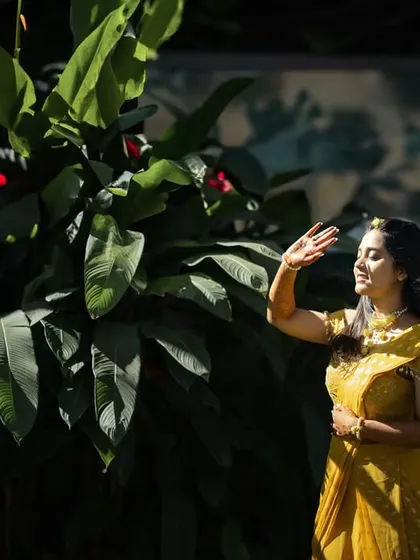 A bride enjoying the morning sun during her Haldi ceremony. The play of light and shadow across her face creates a beautiful, natural portrait.