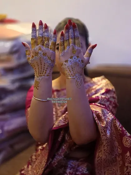 Another view of the stunning white and gold henna design. It looks like jewelry on the hands and is sure to make you stand out.