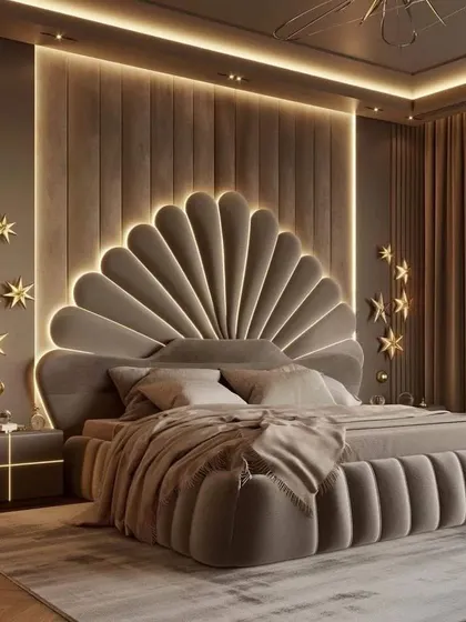 This opulent bedroom design showcases a full-wall upholstered panel behind a grand, shell-shaped headboard. Gold star accents and integrated ceiling and wall lighting create a dreamy, luxurious atmosphere.