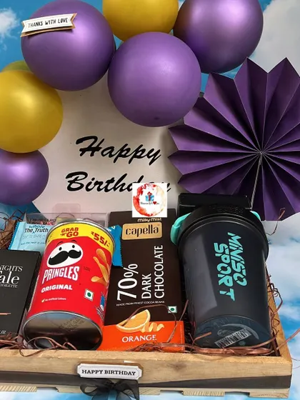 Another view of our popular birthday hamper for him, showing the arrangement of the sports shaker, snacks, and decorative elements in a wooden tray.