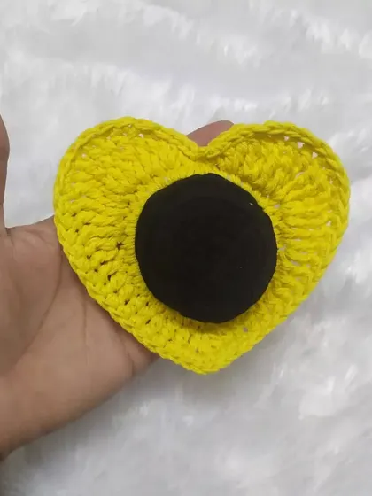 The heart scrunchie in a sunny yellow color. It's a fun and unique way to style your hair.