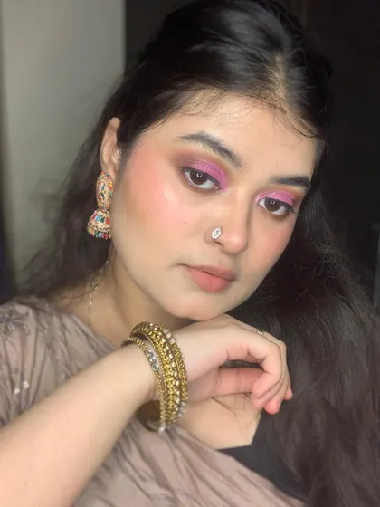Another shot of the pink glittery eye, paired with bangles.