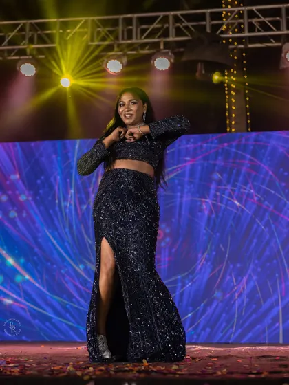 A bride's solo performance on the Sangeet stage, her energy and joy lighting up the event.