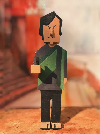 A full-length view of the Feluda wooden figurine. The details, from his shawl to his confident stance, are all hand-painted to honor the character's memorable appearance in the film.