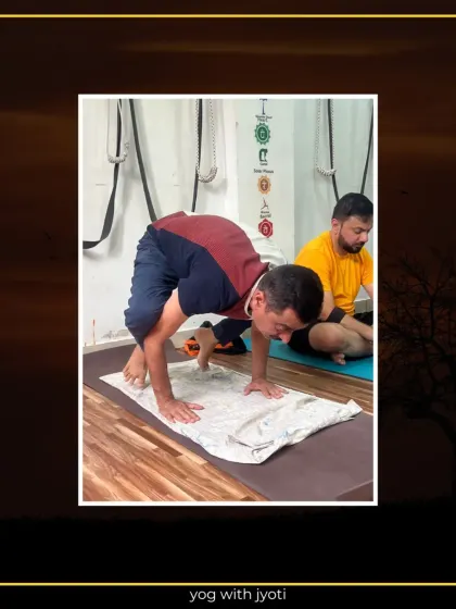 A student practices Crow Pose using a folded towel for wrist support, a great modification for beginners.