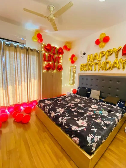 A closer look at the bedroom area of the romantic decoration, showing the balloon arrangement and foil letters.