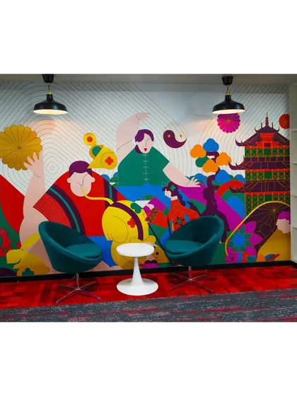 This cozy nook in the Mindsprint office features a colorful, abstract mural and comfortable seating. It's designed as a quiet escape for employees to read, think, or have a private conversation.
