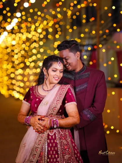 An intimate moment between a couple, surrounded by the warm glow of fairy lights. This photo captures the magic of a wedding evening.