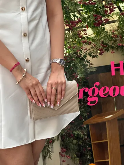 A close-up on the accessories. I paired the white dress with a classic YSL bag, showing how a luxury piece can elevate an affordable outfit.