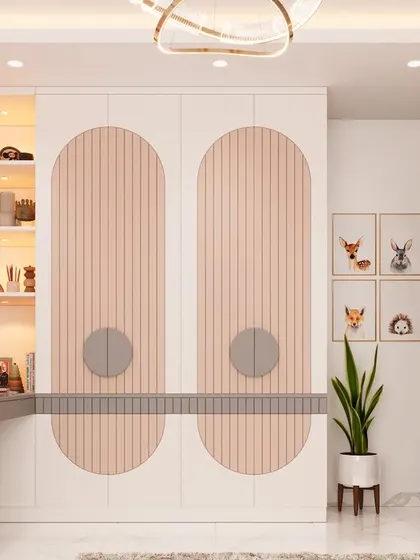 A stylish wardrobe and study combination for a kids' room. The wardrobe features fluted panels and unique circular handles, with an adjoining desk and open shelving for books and decor.
