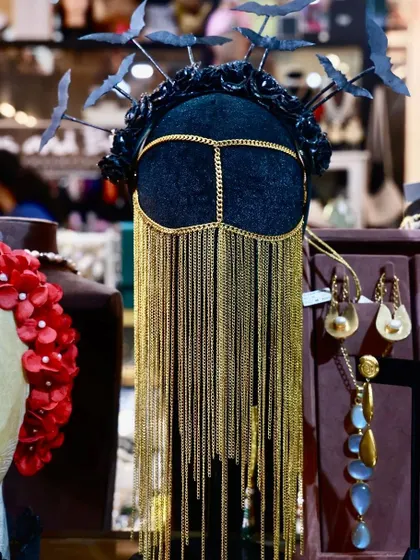 This is for the ones who dare to be different. This avant-garde headpiece with its intricate golden chains and bat-wing details is the ultimate statement piece. It’s proof that we don’t do cookie-cutter accessories; we create wearable art.