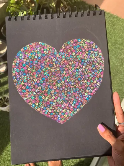 The floral heart artwork in the sunlight, making the colors pop.