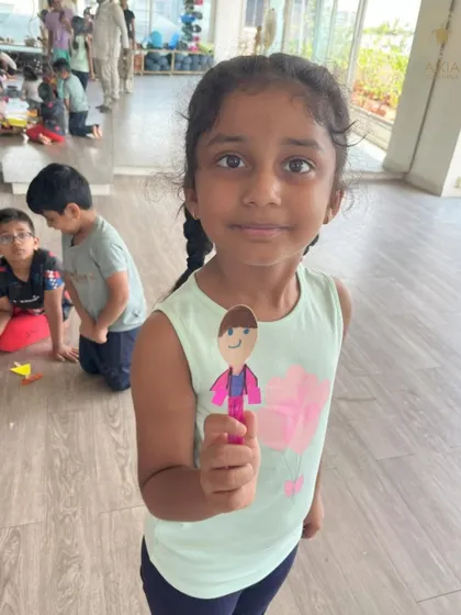 Craft time at Bala Shivir is all about imagination. A young camper proudly displays the puppet she made, a fun activity that encourages creativity and self-expression.