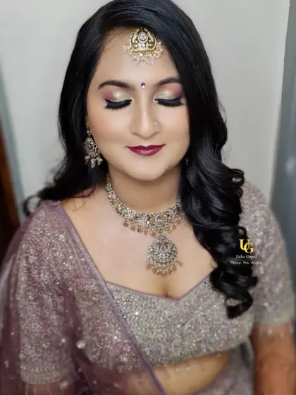 This reception look features a glittery smokey eye and a deep berry lip. I teach techniques for creating these popular party styles, including how to make your makeup last all night.