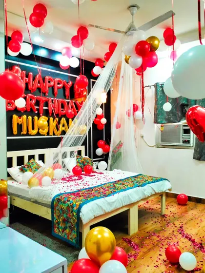 A wide view of the romantic bedroom setup for "Muskan", showing how the balloons fill the room and create a festive and loving environment.