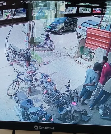 This camera is monitoring the outside of a commercial establishment, covering the vehicle parking area.